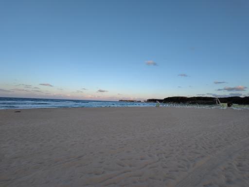 The evening Black Sea beach without any people. The sky is blue and calm, waves are strong.